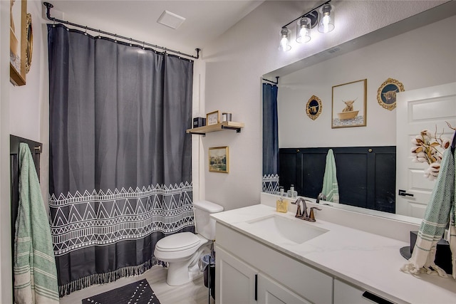 bathroom with vanity, visible vents, and toilet