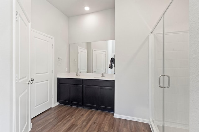 1421 Avalon Ct, Celina, TX 75009 - full bathroom featuring wood finished floors, a stall shower, double vanity, baseboards, and recessed lighting