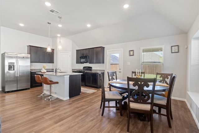 1421 Avalon Ct, Celina, TX 75009 - dining area with lofted ceiling, light wood-style floors, recessed lighting, and baseboards