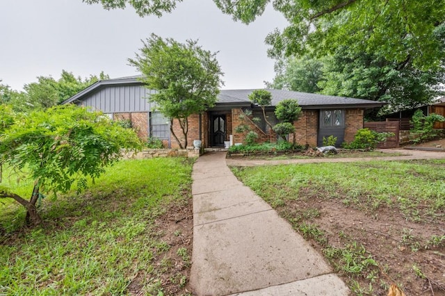 ranch-style home featuring brick siding