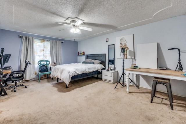 bedroom with a ceiling fan, a textured ceiling, and light carpet