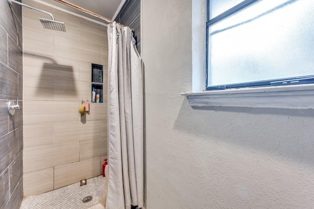 full bathroom with tiled shower