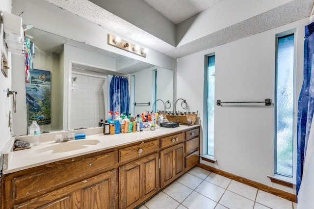 bathroom featuring tile patterned flooring, plenty of natural light, vanity, and a shower with shower curtain