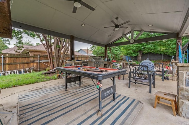 view of patio with grilling area, a fenced backyard, area for grilling, a ceiling fan, and outdoor dining space
