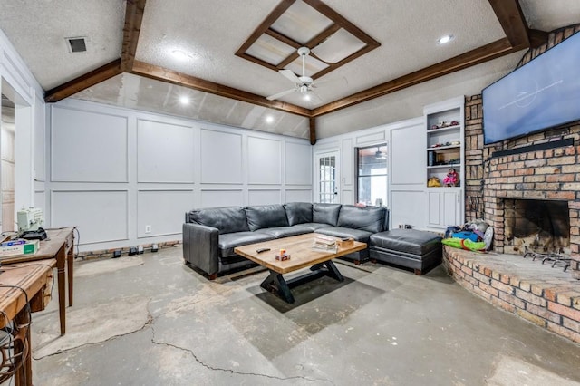 living room featuring a ceiling fan, visible vents, a fireplace, concrete flooring, and a decorative wall