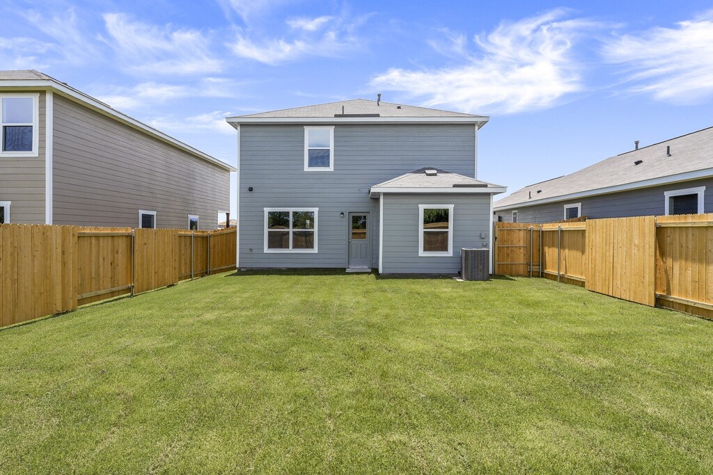 1416 Reiner Dr, Crandall, TX 75114 - rear view of house featuring a yard, a fenced backyard, and central air condition unit