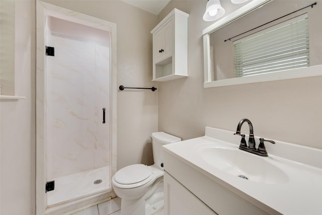 bathroom featuring vanity, a stall shower, and toilet