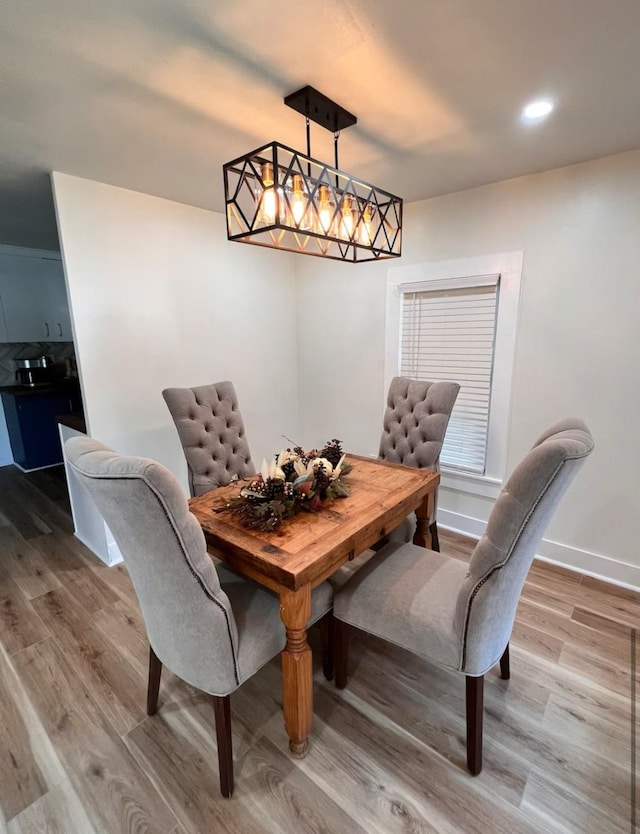dining area featuring baseboards, recessed lighting, and wood finished floors