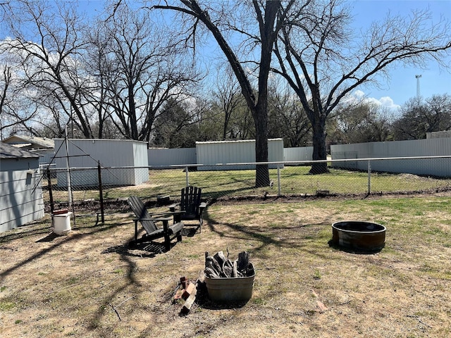 view of yard with fence and an outdoor structure