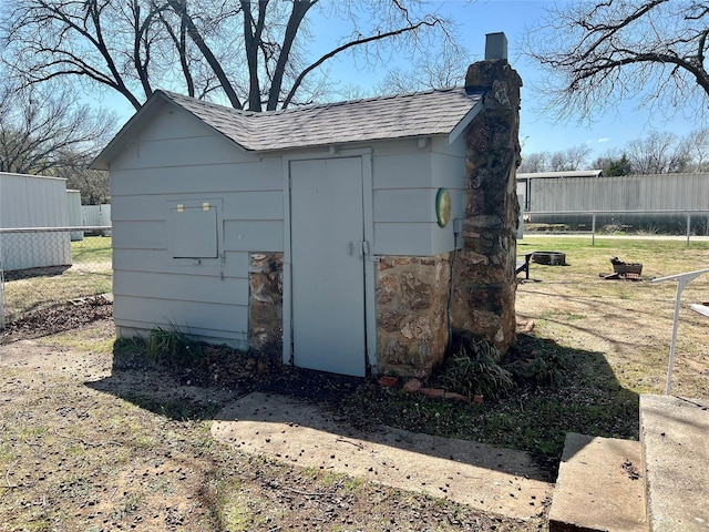view of shed featuring fence