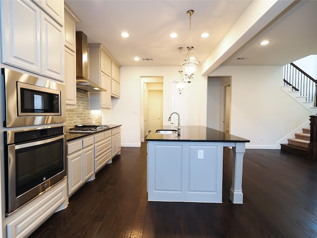 6900 Royal Liverpool Dr, Mckinney, TX 75070 - kitchen with dark countertops, baseboards, wall chimney range hood, a sink, and appliances with stainless steel finishes