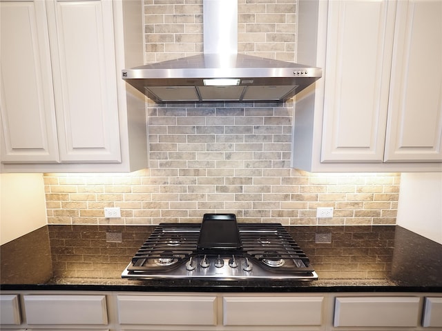 6900 Royal Liverpool Dr, Mckinney, TX 75070 - kitchen with dark countertops, wall chimney exhaust hood, white cabinetry, backsplash, and stainless steel gas stovetop