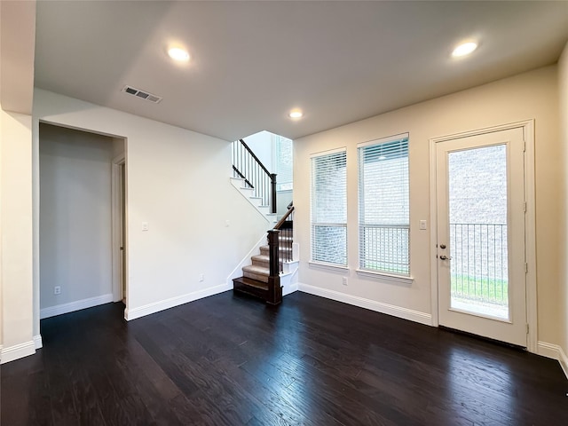 6900 Royal Liverpool Dr, Mckinney, TX 75070 - unfurnished living room with baseboards, visible vents, dark wood-style floors, and stairway