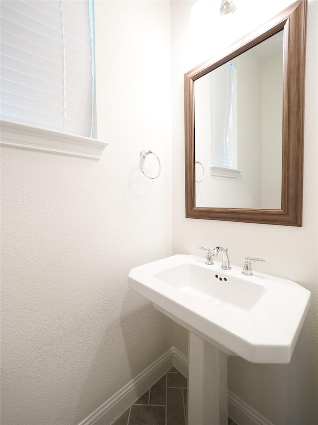 6900 Royal Liverpool Dr, Mckinney, TX 75070 - bathroom featuring tile patterned floors, a sink, and baseboards