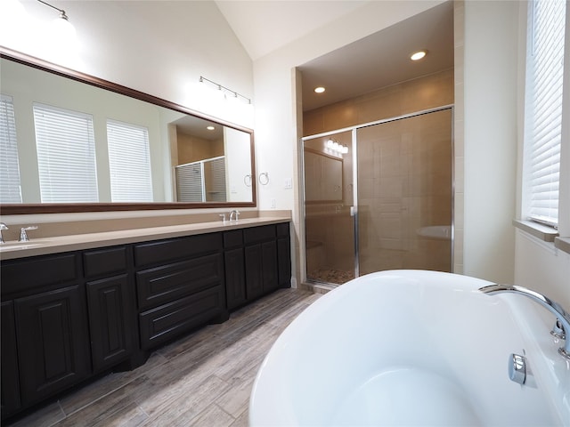 6900 Royal Liverpool Dr, Mckinney, TX 75070 - full bath featuring double vanity, a bathtub, a stall shower, wood finished floors, and a sink