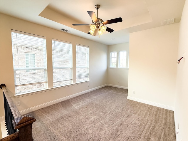 6900 Royal Liverpool Dr, Mckinney, TX 75070 - unfurnished room featuring a raised ceiling, baseboards, a ceiling fan, and visible vents