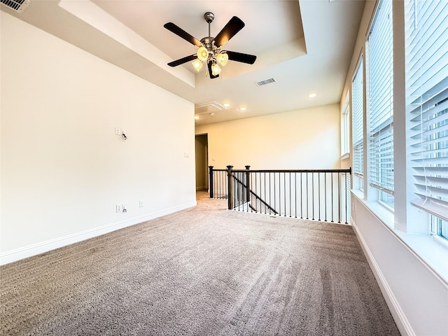 6900 Royal Liverpool Dr, Mckinney, TX 75070 - spare room with ceiling fan, visible vents, a raised ceiling, baseboards, and carpet flooring