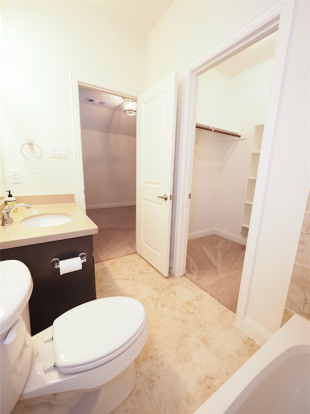 6900 Royal Liverpool Dr, Mckinney, TX 75070 - bathroom featuring vanity, toilet, a spacious closet, and visible vents