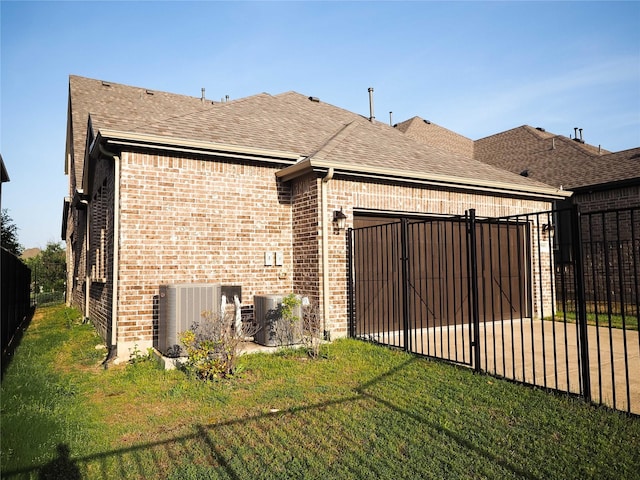 6900 Royal Liverpool Dr, Mckinney, TX 75070 - rear view of house with central air condition unit, fence, a garage, and brick siding
