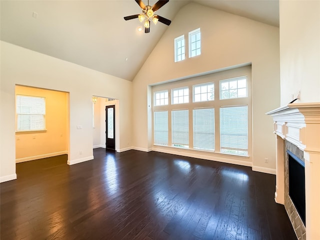 6900 Royal Liverpool Dr, Mckinney, TX 75070 - unfurnished living room with high vaulted ceiling, a ceiling fan, baseboards, a tile fireplace, and hardwood / wood-style flooring
