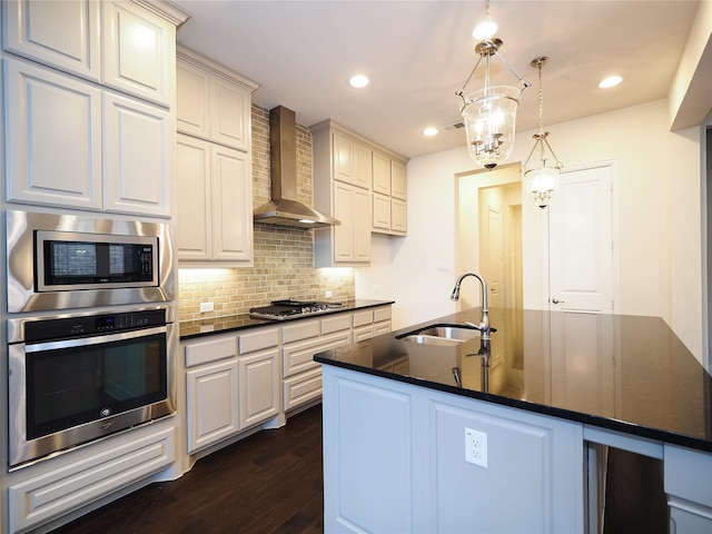 6900 Royal Liverpool Dr, Mckinney, TX 75070 - kitchen featuring wall chimney range hood, decorative backsplash, a sink, dark wood-style floors, and stainless steel appliances