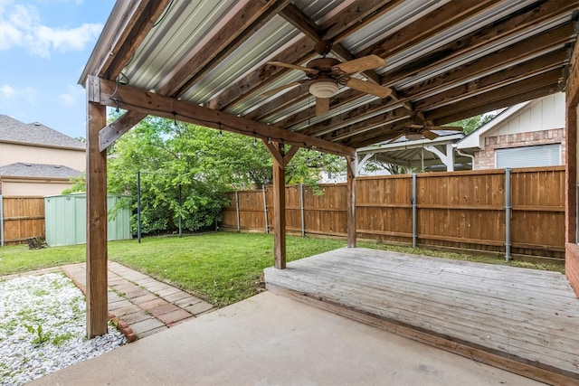 view of patio with an outdoor structure, a ceiling fan, a fenced backyard, and a storage shed