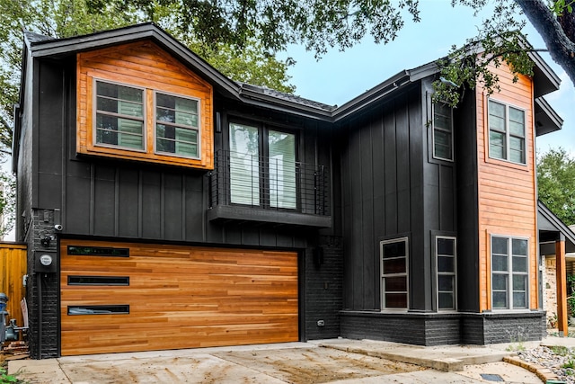 view of front facade with an attached garage, board and batten siding, and driveway