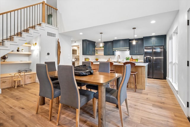 3219 Bryan St, Dallas, TX 75204 - dining room featuring light wood-style floors, recessed lighting, a desk, and stairway