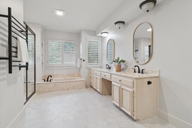 full bathroom with double vanity, baseboards, a sink, and a bath
