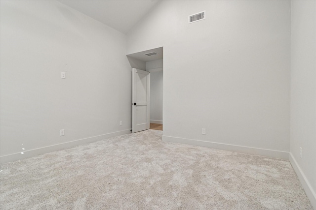 unfurnished bedroom featuring visible vents, baseboards, and light colored carpet