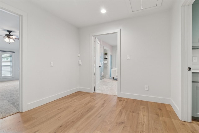 interior space featuring light wood-style flooring, attic access, a ceiling fan, baseboards, and recessed lighting