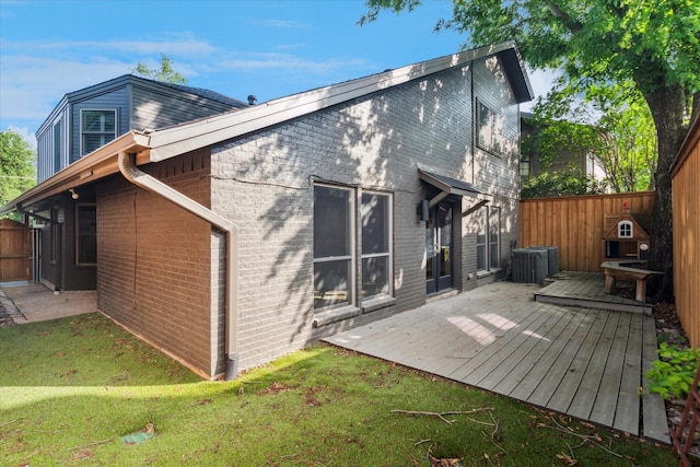 3219 Bryan St, Dallas, TX 75204 - back of house featuring a deck, brick siding, and cooling unit