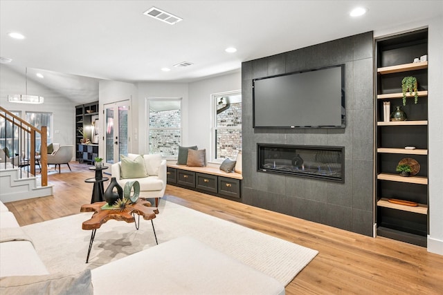 3219 Bryan St, Dallas, TX 75204 - living area with light wood-type flooring, stairs, a fireplace, recessed lighting, and built in shelves