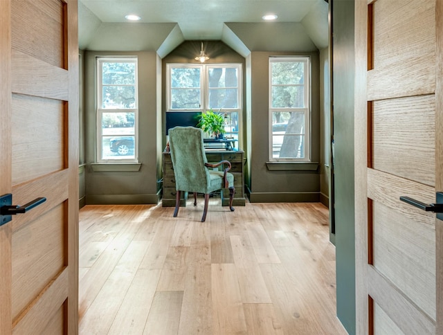 interior space with recessed lighting, baseboards, vaulted ceiling, and light wood-type flooring
