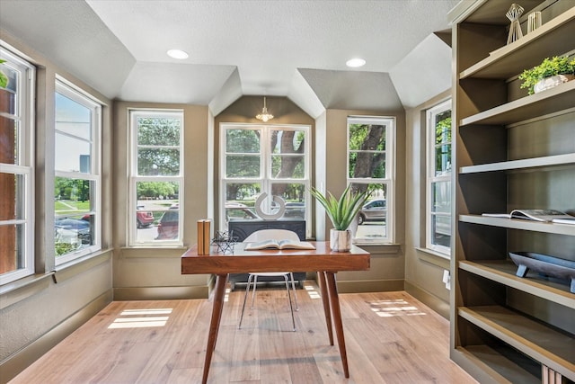 3219 Bryan St, Dallas, TX 75204 - home office with light wood-type flooring, a textured ceiling, lofted ceiling, and baseboards