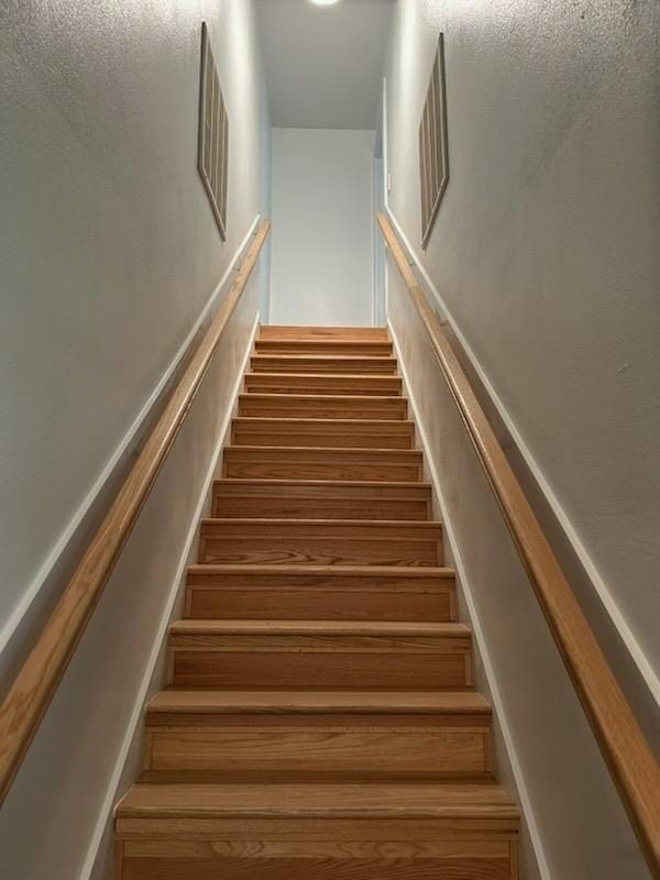 staircase featuring visible vents