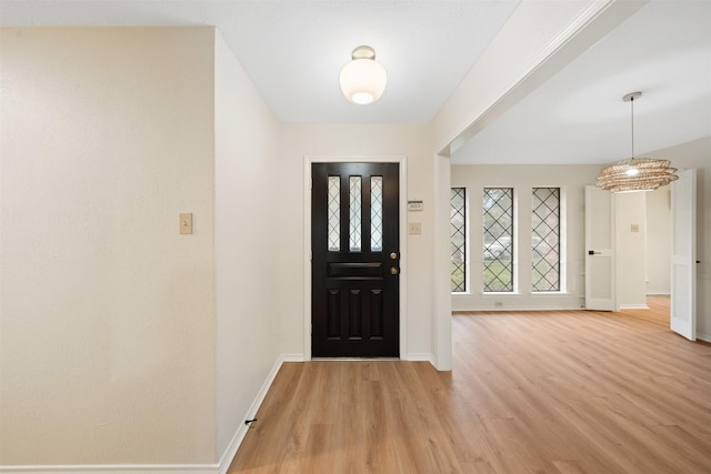 entryway featuring light wood-style floors and baseboards