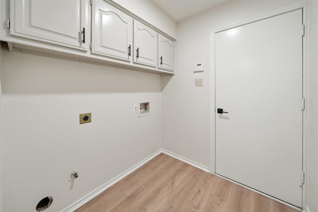 clothes washing area with baseboards, hookup for a washing machine, cabinet space, electric dryer hookup, and light wood-style flooring