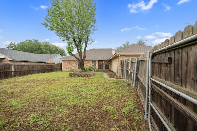 view of yard with a fenced backyard