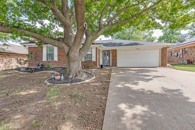 view of front facade with brick siding, an attached garage, and concrete driveway