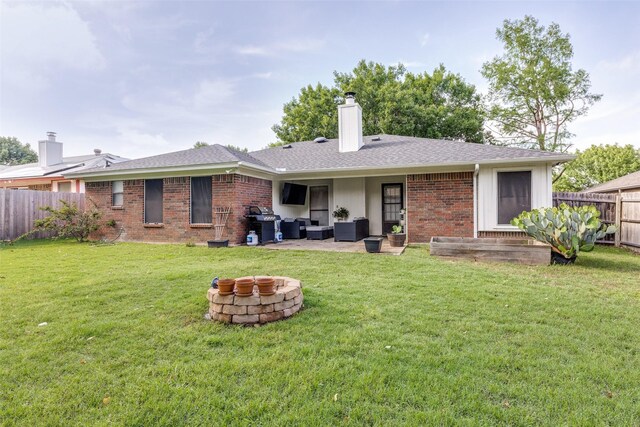 back of property with fence, a chimney, an outdoor hangout area, brick siding, and a patio area