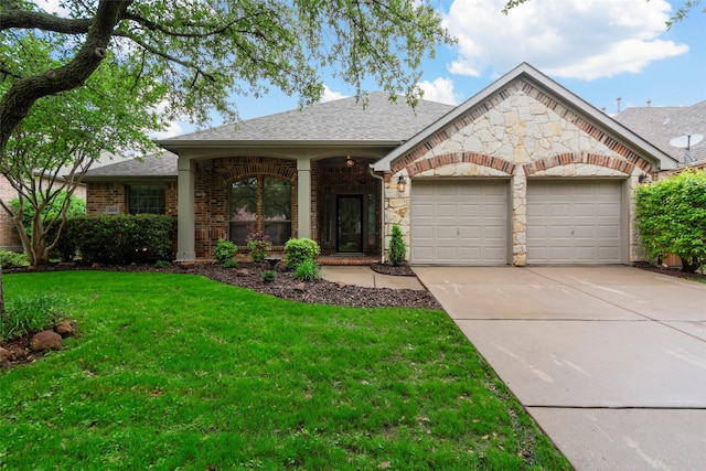 ranch-style house featuring roof with shingles, a front yard, a garage, brick siding, and concrete driveway