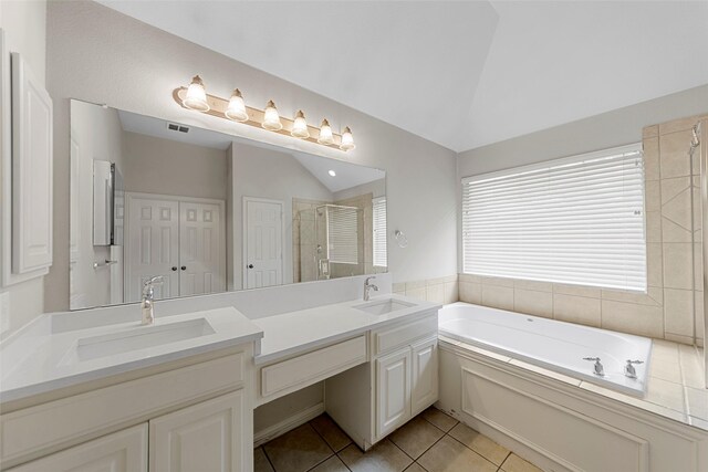 full bathroom with a sink, tile patterned flooring, a shower stall, and lofted ceiling