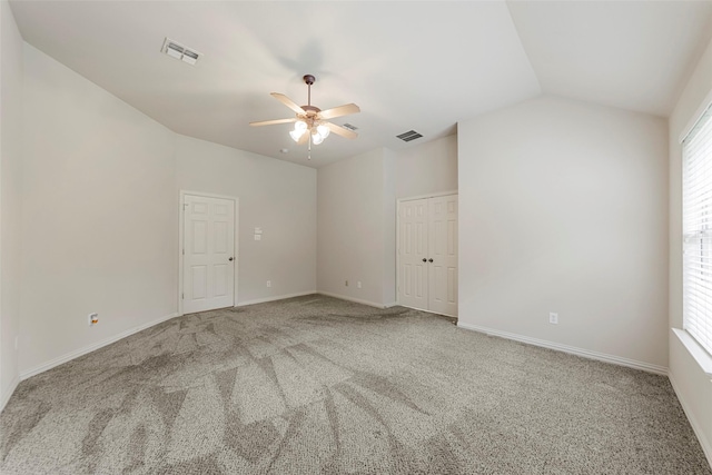 empty room with a ceiling fan, carpet flooring, and visible vents