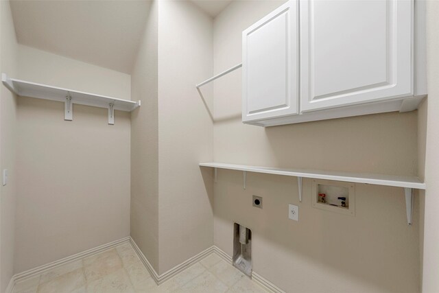 washroom with baseboards, hookup for an electric dryer, hookup for a washing machine, and cabinet space