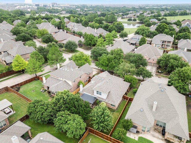 birds eye view of property featuring a water view and a residential view