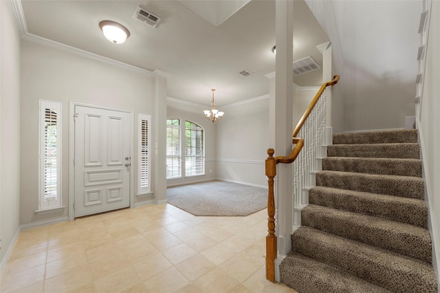 entrance foyer featuring visible vents, baseboards, crown molding, and stairway