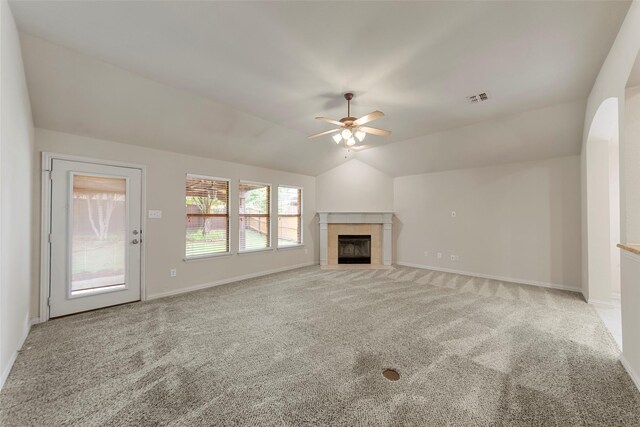 unfurnished living room with visible vents, carpet, ceiling fan, and lofted ceiling