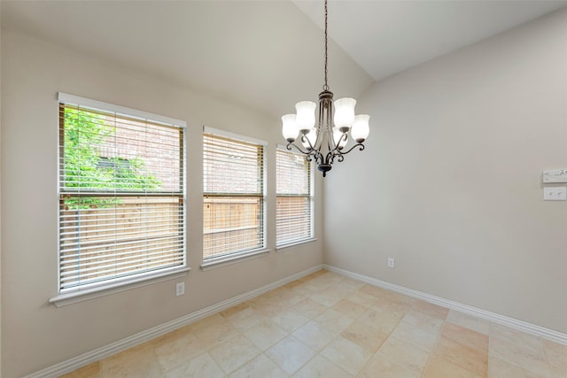 spare room featuring baseboards, an inviting chandelier, and lofted ceiling