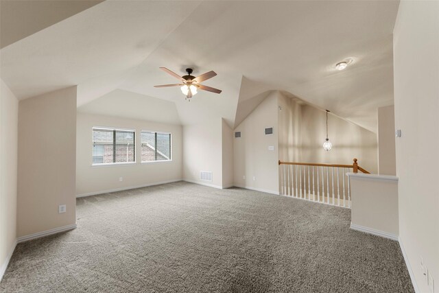 additional living space featuring carpet floors, ceiling fan, visible vents, and lofted ceiling